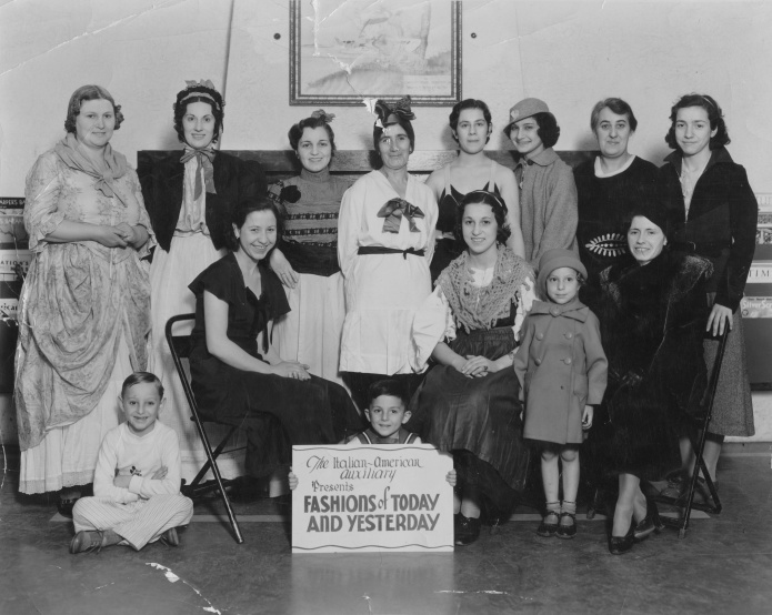 “Italian-American Auxiliary Presents Fashions of Today and Yesterday.” Grandma Mary Amelang (nee Stabile) is seated center-right, in peasant dress and shawl.